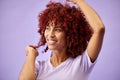 Black woman, hair care and face with smile, natural afro and growth for glow and shine in studio on purple background Royalty Free Stock Photo