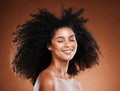 Black woman, hair care and natural afro, smile and beauty against brown studio background. Happy young african american Royalty Free Stock Photo