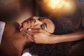 Black woman, hands and masseuse for face massage, beauty and bodycare at spa for stress relief and wellness. Dermatology
