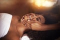 Black woman, hands and masseuse for facial massage, beauty and bodycare at spa for stress relief and wellness