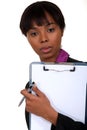 Black woman holding clipboard. Royalty Free Stock Photo