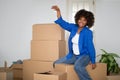 Black Woman Holding Home Keys And Sitting On Cardboard Box After Moving Royalty Free Stock Photo