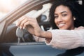 Black car driver woman smiling showing new car keys and car Royalty Free Stock Photo