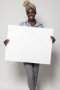 Black Woman Holding a White Sign in Business Pants and Shirt