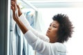 Black woman, home and hygiene with hanging laundry for housekeeping, duties and domestic. Female person, washing and Royalty Free Stock Photo