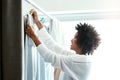 Black woman, home and smile with hanging clothes for housekeeping, duties and domestic. Female person, washing and Royalty Free Stock Photo