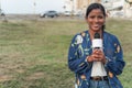 African woman journalist speaking into microphone