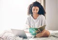 Black woman, laptop and writing notes on bed in remote work for consulting, telemarketing or sales at home. Happy Royalty Free Stock Photo