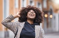 Black woman, laughing and afro hair in city fun, goofy or silly travel in urban New York or holiday location. Smile