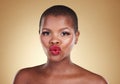 Black woman, lips and kiss, red lipstick and beauty with makeup and portrait isolated on studio background. Pout