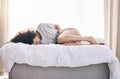 Black woman, lying or stress stomach ache on bed, home or house bedroom in period pain, menstruation cramps or ibs Royalty Free Stock Photo