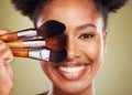 Black woman, makeup brush and smile in studio for beauty portrait, wellness and cosmetics by backdrop. African woman Royalty Free Stock Photo