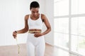 Black Woman Measuring Waist With Tape. Dieting Slimming Concept Royalty Free Stock Photo