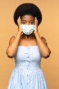 Frightened african woman in medical mask scared of vaccination and coronavirus vaccine injection Royalty Free Stock Photo