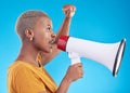 Black woman, megaphone and protest in studio, shout or profile with fist in air for human rights by blue background