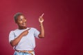 Black woman, mockup and pointing for advertising, marketing or banner against a studio background. Happy African Royalty Free Stock Photo
