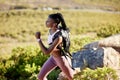 Black woman, mountain runner and outdoor for fitness, speed or challenge for wellness with focus in summer. African girl Royalty Free Stock Photo