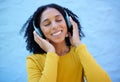 Black woman, music headphones and smile on wall background, blue backdrop or outdoor. Happy girl listening to radio Royalty Free Stock Photo