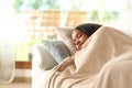 Black woman napping on a sofa in a house interior Royalty Free Stock Photo