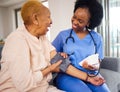 Black woman, nurse and caregiver for blood pressure, elderly care or healthcare on sofa at home. African female person