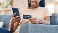 Black woman, online shopping and ecommerce phone payment on credit card, mobile money and internet finance on home sofa Royalty Free Stock Photo