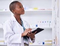 Black woman, pharmacist and tablet for inventory inspection or checking stock at the pharmacy. African female person in Royalty Free Stock Photo