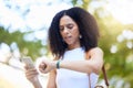 Black woman, phone and checking time on watch for schedule, appointment or planning in the park. African American female Royalty Free Stock Photo