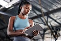 Black woman, planning or personal trainer with a tablet for fitness training, workout or sports exercise. Progress