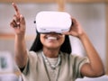 Black woman, pointing and virtual reality glasses for metaverse, smile and games in living room. Vr, Nigerian female and