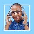 Black woman, portrait and headphones for music with a smile for motivation with blue background. Face of African model Royalty Free Stock Photo