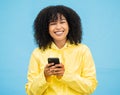 Black woman, portrait and phone with a person smile with blue studio background, Isolated, happiness and social media Royalty Free Stock Photo