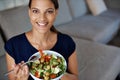 Black woman, portrait and salad for food, eating and diet on sofa, couch and lounge. Vegan lady, happy female person and Royalty Free Stock Photo