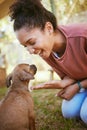 Black woman, puppy and happy with smile, playful and being loving outdoor on grass. Love, African American female and