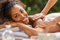 Black woman relaxing during spa massage