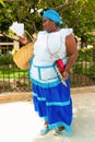 Black woman selling roasted peanuts in Havana