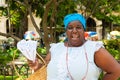 Black woman selling roasted peanuts in Havana