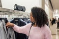 Black woman shopping clothes in a store