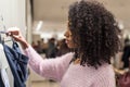 Black woman shopping clothes in a store