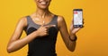 Black Woman Showing Phone With Step Counter App, Yellow Background