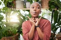 Black woman, silly face and green house plant with comedy feeling happy feeling shy. African female person, girl and