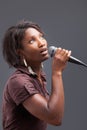 Black Woman Singing Into Microphone Royalty Free Stock Photo