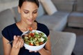 Black woman, smile and salad for eating, food and health on sofa, couch and lounge at home, house or living room. Female Royalty Free Stock Photo