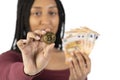 Black woman with some fifty euro bills shows a bitcoin on a white background