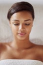 Black woman, spa and face for luxury massage at resort to relax, rest and stress relief for wellness. Young female Royalty Free Stock Photo