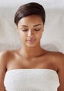 Black woman, spa and luxury massage in portrait for rest, relax and healthy stress relief. Young, female person and face Royalty Free Stock Photo