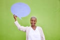 Black woman, speech bubble and portrait for mockup space, smile and opinion by green wall background. African girl