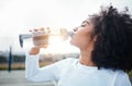 Black woman, sports and drinking water at court during training, workout and sport exercise outdoors. Fitness, thirsty Royalty Free Stock Photo