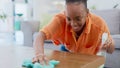 Black woman, spray bottle and cleaning table for housekeeping, hygiene or domestic service at home. Happy African female Royalty Free Stock Photo