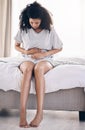 Black woman, stress or stomach ache on house bed, home or bedroom in period pain, menstruation cramps or ibs crisis Royalty Free Stock Photo