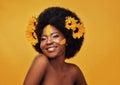 Black woman, studio and smile with sunflower and hairstyle, portrait with cosmetics and afro. Female person, aesthetics Royalty Free Stock Photo